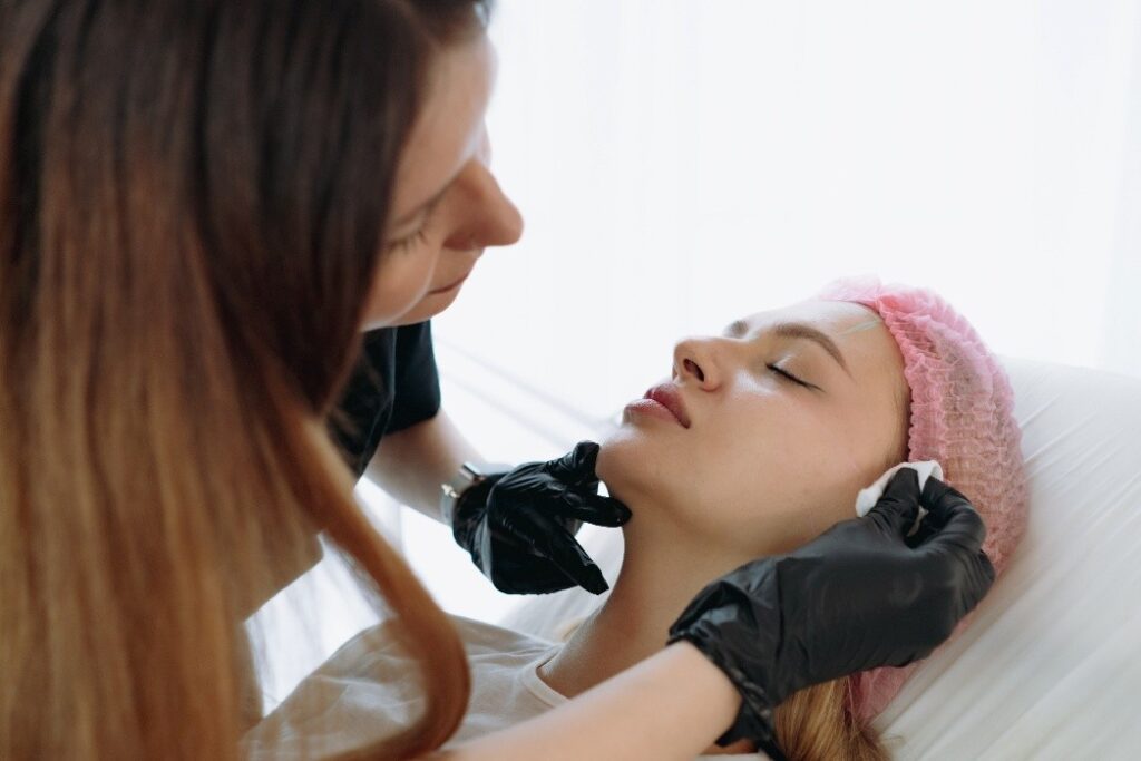A woman getting a treatment done on her face